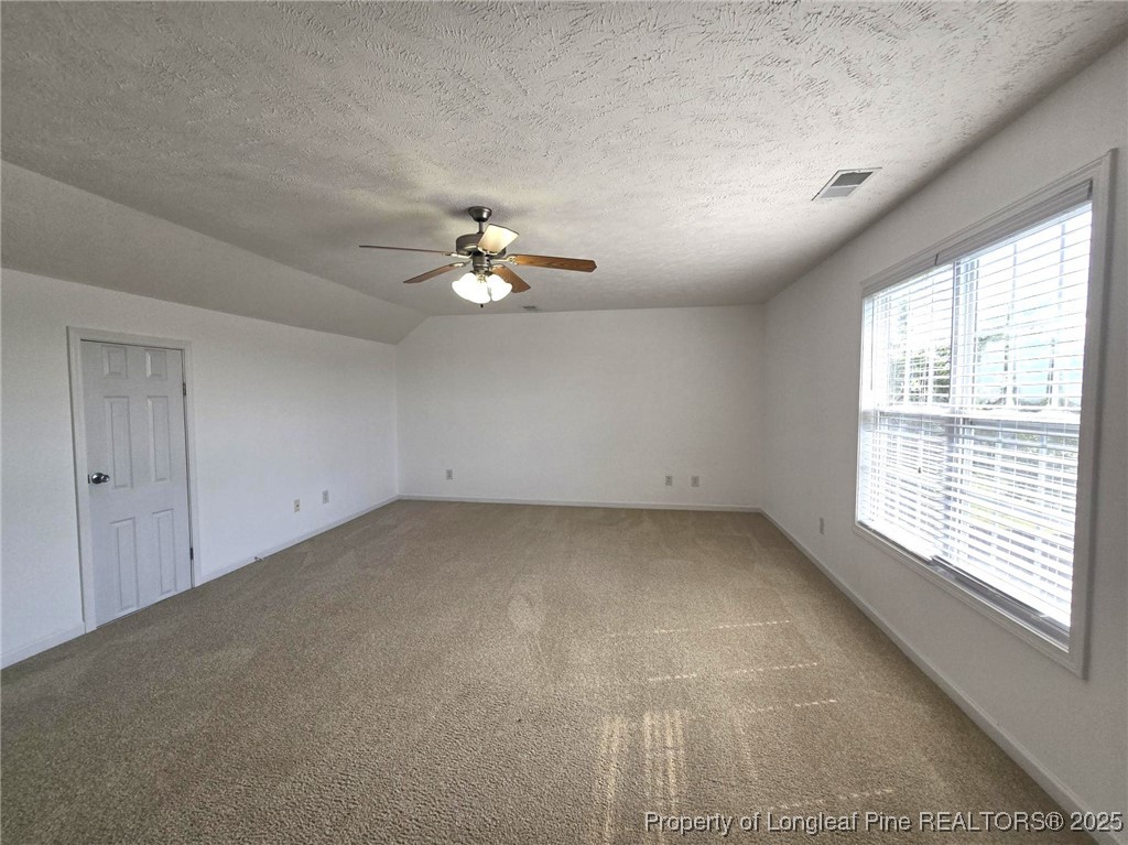 115 Haywood Street Spring Lake, NC 28390 - Photo 35 of 35 an empty room with chandelier fan and windows