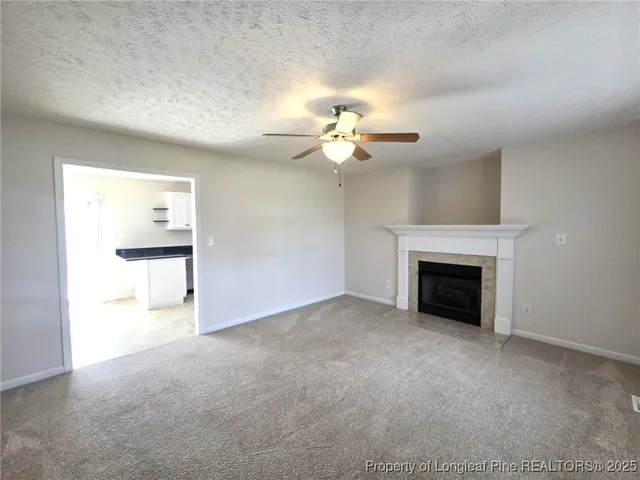 a view of an empty room with a fireplace