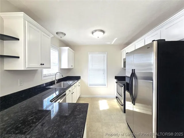 a kitchen with a refrigerator and a sink