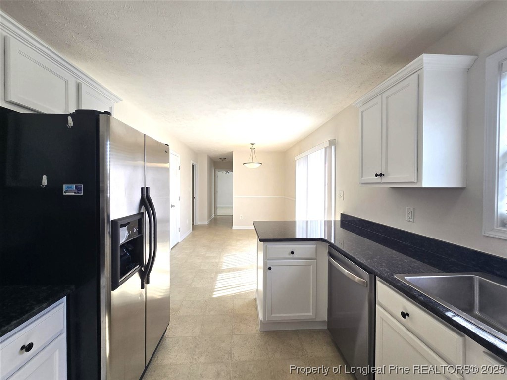 115 Haywood Street Spring Lake, NC 28390 - Photo 10 of 35 a kitchen with stainless steel appliances granite countertop a refrigerator and a sink