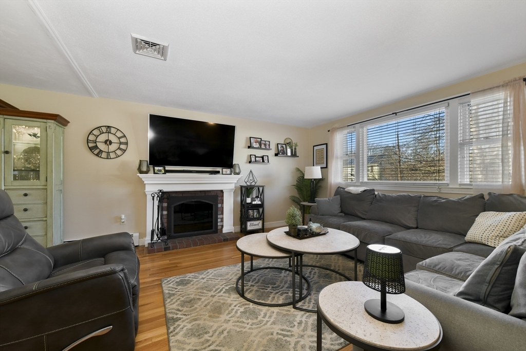 36 Taft Avenue Beverly, MA 01915 - Photo 12 of 36 a living room with furniture a fireplace and a flat screen tv
