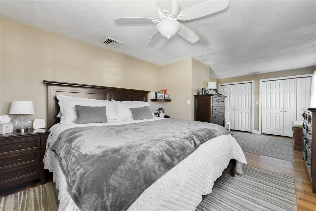 36 Taft Avenue Beverly, MA 01915 - Photo 13 of 36 a spacious bedroom with a bed and a chandelier