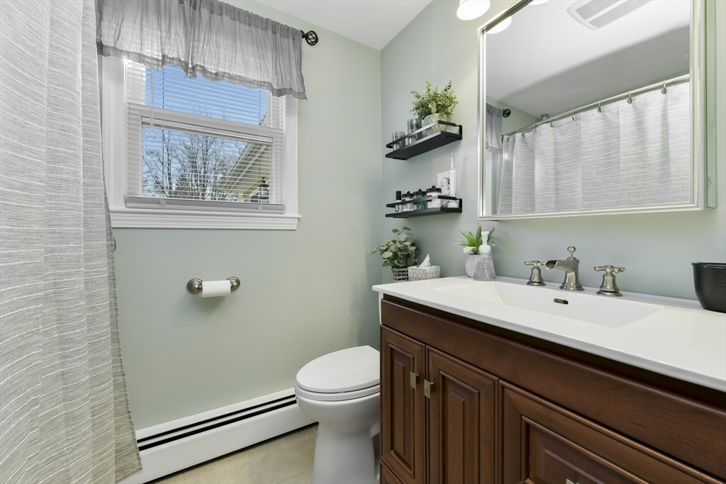 36 Taft Avenue Beverly, MA 01915 - Photo 17 of 36 a bathroom with a granite countertop sink mirror vanity and toilet