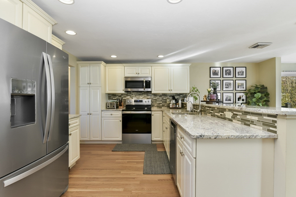 36 Taft Avenue Beverly, MA 01915 - Photo 2 of 36 a kitchen with stainless steel appliances granite countertop a refrigerator sink and stove