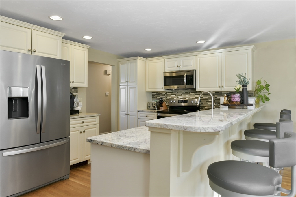 36 Taft Avenue Beverly, MA 01915 - Photo 3 of 36 a kitchen with kitchen island granite countertop stainless steel appliances and refrigerator