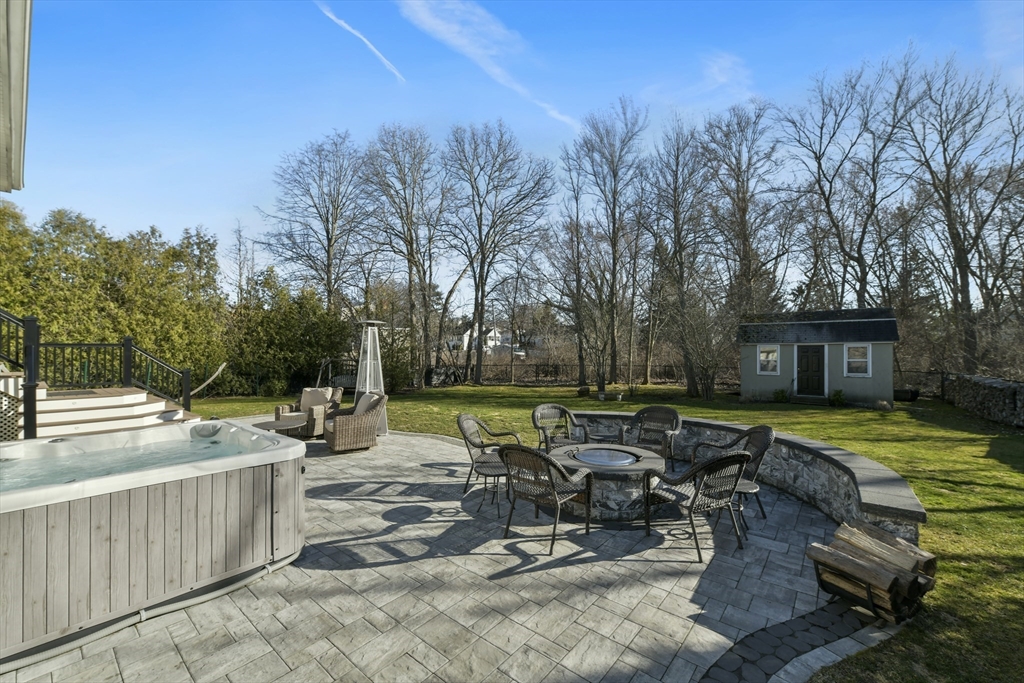 36 Taft Avenue Beverly, MA 01915 - Photo 33 of 36 a view of a patio with table and chairs and potted plants with wooden fence