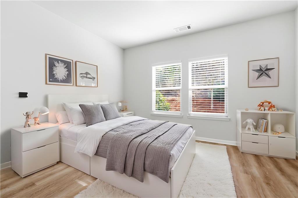 2779 Morgan Spring Trail Buford, GA 30519 - Photo 29 of 64 a bedroom with a white bed and a table