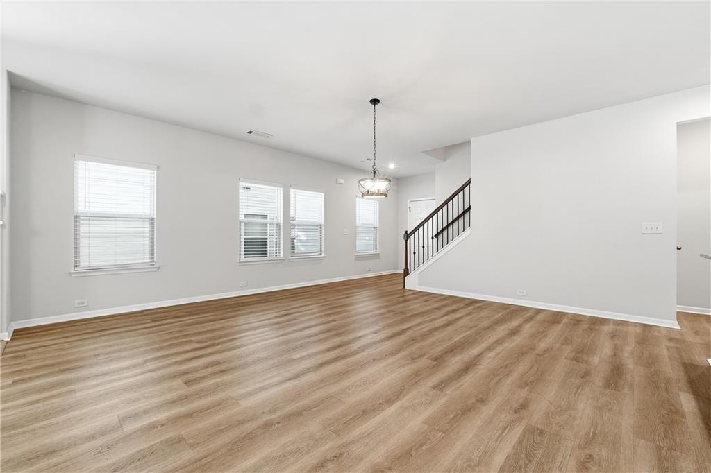 2779 Morgan Spring Trail Buford, GA 30519 - Photo 30 of 64 an empty room with wooden floor and windows