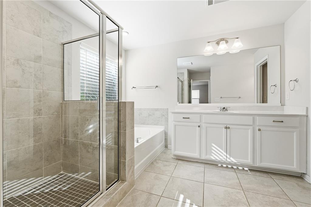 2779 Morgan Spring Trail Buford, GA 30519 - Photo 35 of 64 a bathroom with a double vanity sink a mirror and a shower