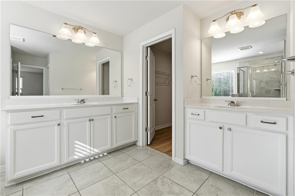 2779 Morgan Spring Trail Buford, GA 30519 - Photo 36 of 64 a bathroom with a double vanity sink and a mirror