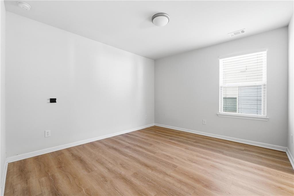 2779 Morgan Spring Trail Buford, GA 30519 - Photo 42 of 64 wooden floor in an empty room with a window