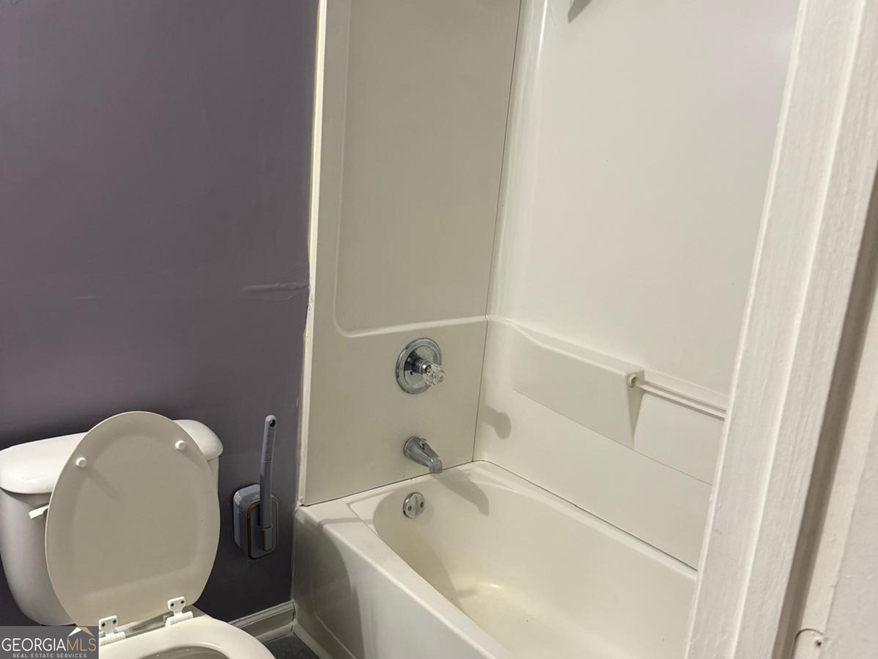 7055 Swift Street Lithonia, GA 30058 - Photo 7 of 9 a bathroom with a bathtub and toilet