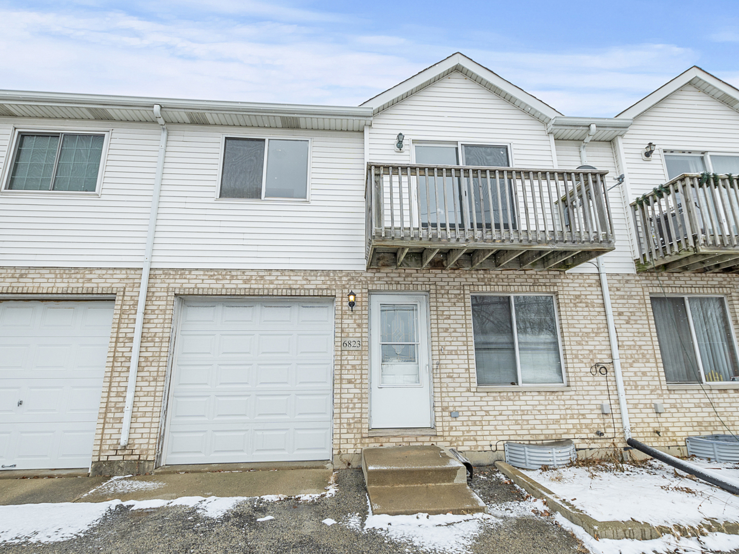 a view of a house with wooden fence