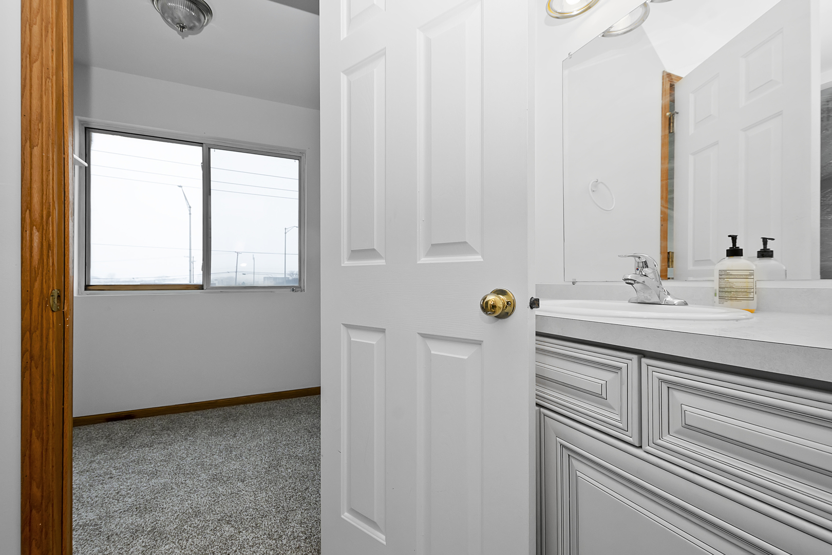 6823 Roberts Road Bridgeview, IL 60455 - Photo 12 of 22 a bathroom with a sink and a mirror