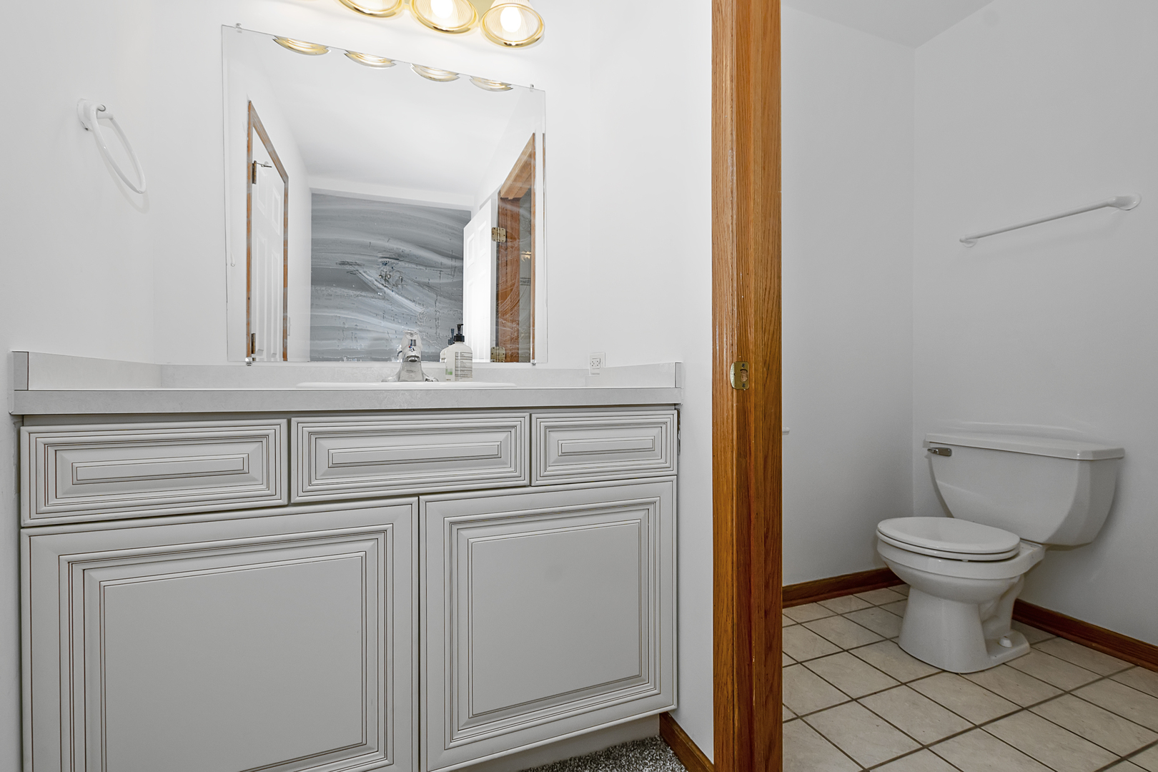 6823 Roberts Road Bridgeview, IL 60455 - Photo 13 of 22 a bathroom with a toilet sink and mirror