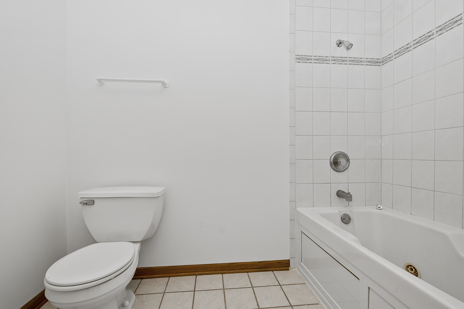 6823 Roberts Road Bridgeview, IL 60455 - Photo 14 of 22 a white toilet sitting next to a bath tub