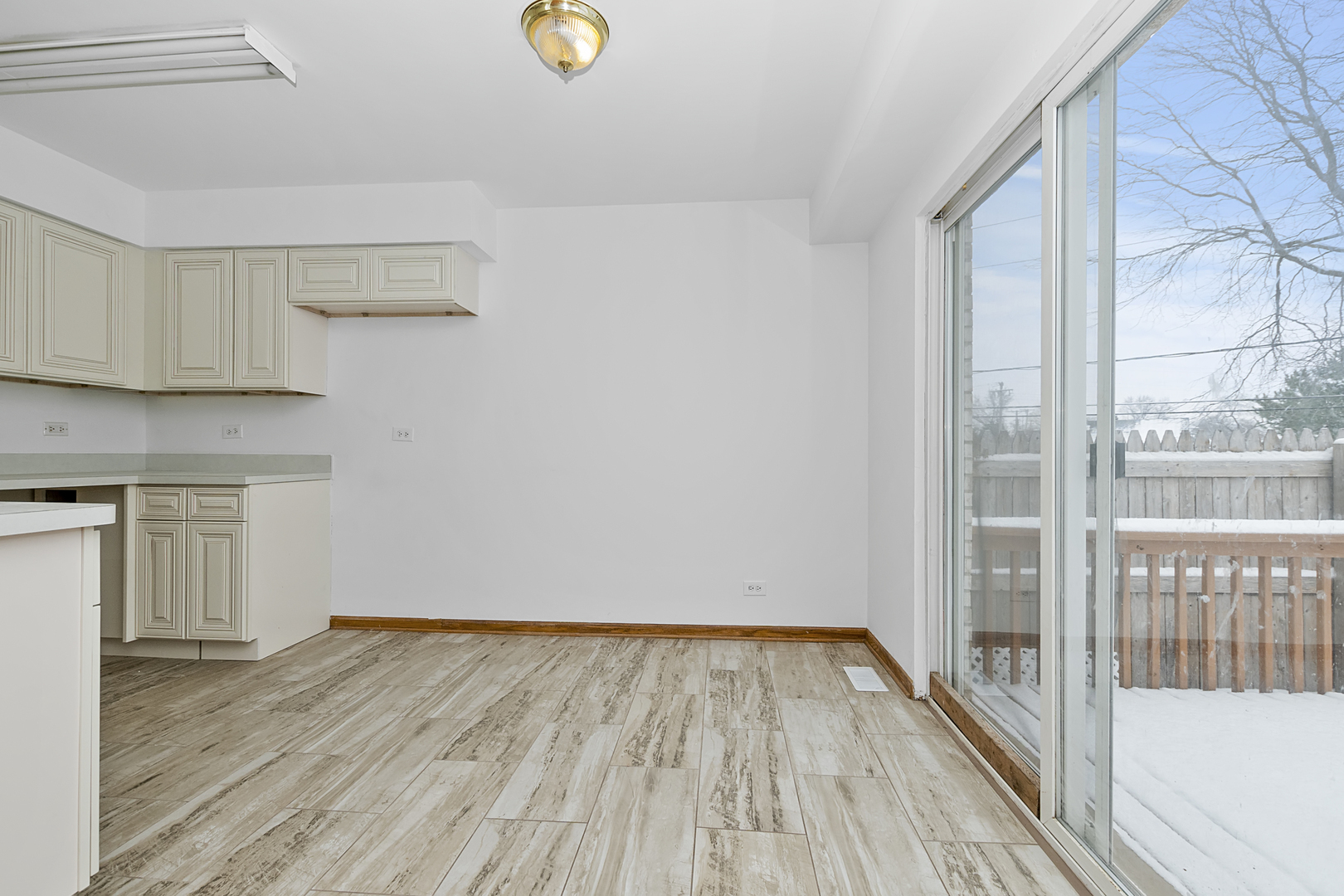 6823 Roberts Road Bridgeview, IL 60455 - Photo 6 of 22 a view of a room with wooden floor and a window