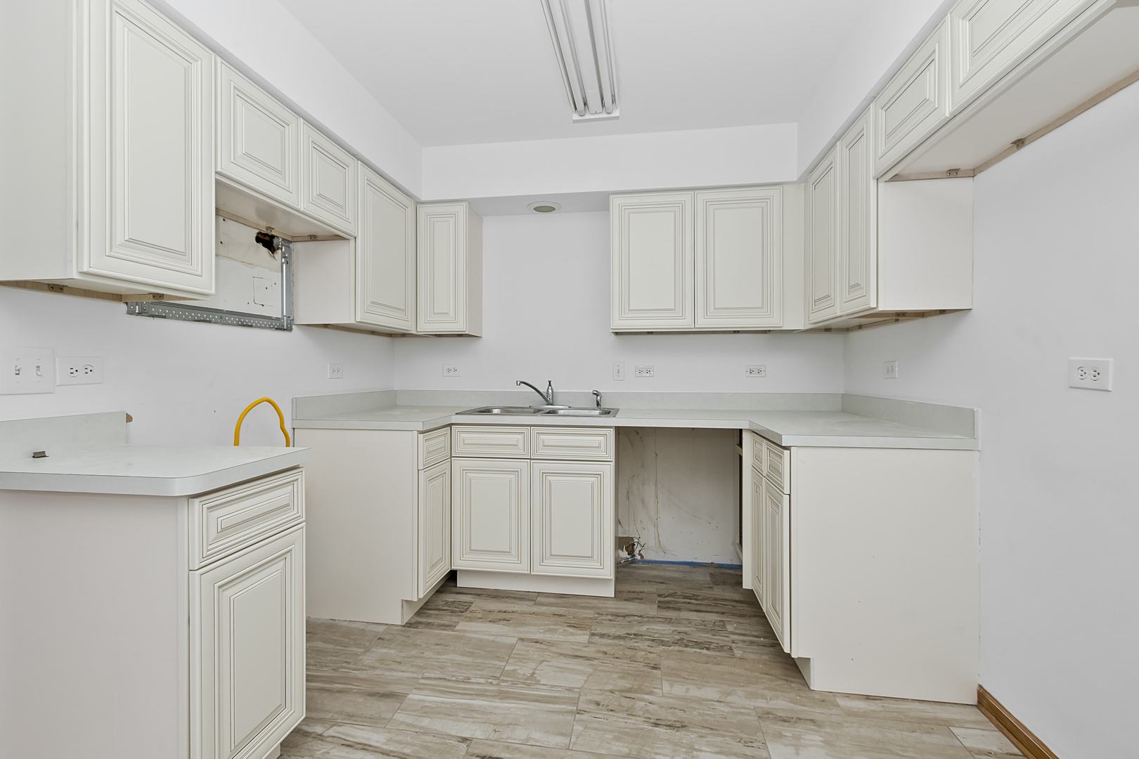 6823 Roberts Road Bridgeview, IL 60455 - Photo 7 of 22 a kitchen with granite countertop white cabinets and white appliances