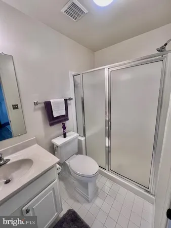 a white toilet sitting next to a bathroom sink