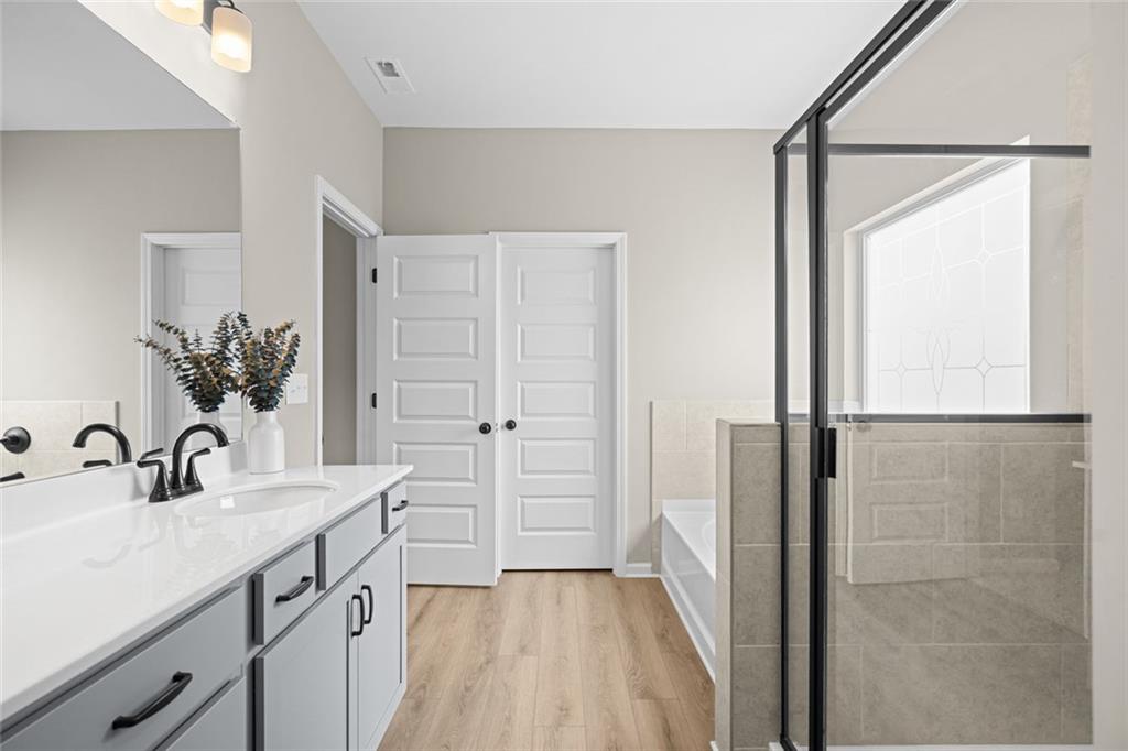 132 Andros Loop Dalton, GA 30721 - Photo 28 of 40 a bathroom with a double vanity sink a mirror and a shower