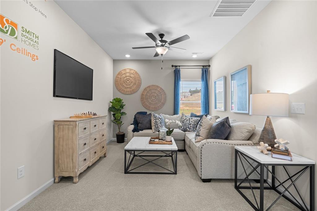 132 Andros Loop Dalton, GA 30721 - Photo 35 of 40 a living room with furniture a large window and a flat screen tv