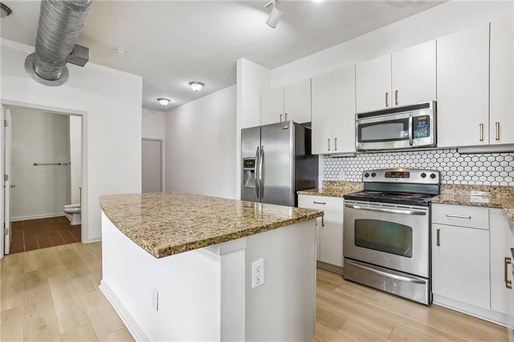 5300 Peachtree Road, Unit 3506 Atlanta, GA 30341 - Photo 6 of 25 a kitchen with stainless steel appliances granite countertop a sink stove and refrigerator