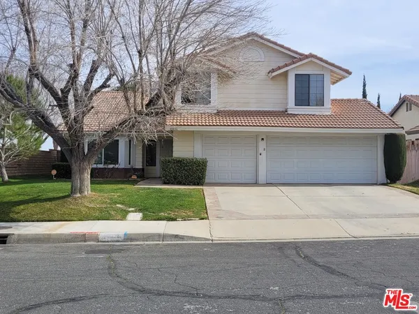 a front view of a house with a yard and a garage