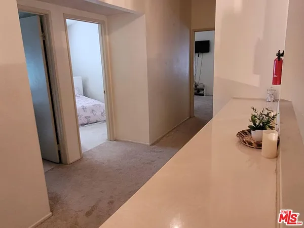 a roof deck with couches and wooden fence