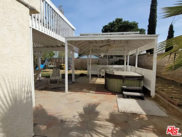 a view of a backyard with swimming pool