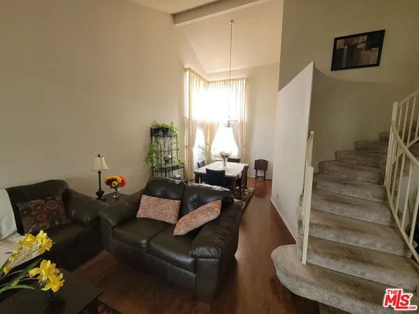 a living room with furniture and a hard wood floor
