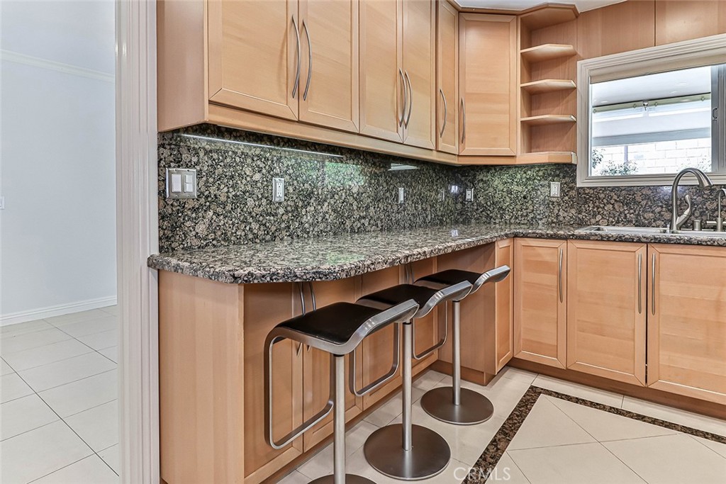 19051 Los Alimos Street Porter Ranch, CA 91326 - Photo 20 of 59 a kitchen with granite countertop a sink and a white cabinets