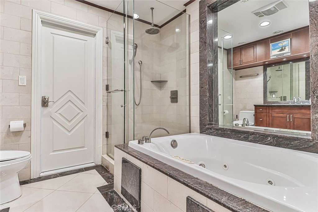 19051 Los Alimos Street Porter Ranch, CA 91326 - Photo 24 of 59 a bathroom with a bathtub and a shower