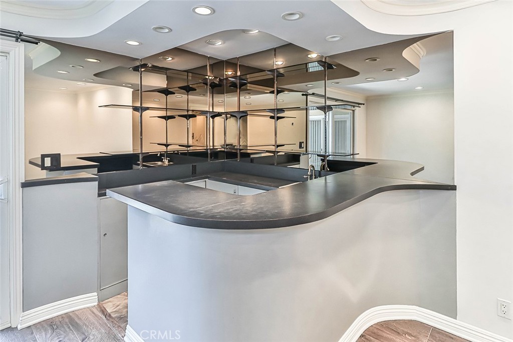 19051 Los Alimos Street Porter Ranch, CA 91326 - Photo 29 of 59 a view of a sink a counter top space with granite countertop a sink