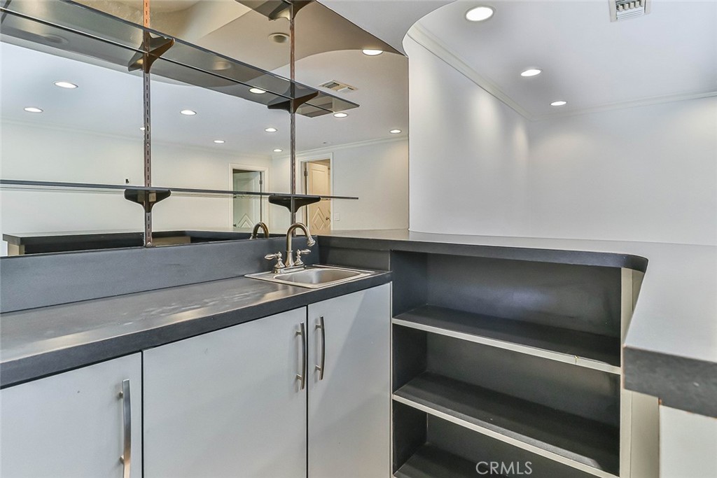 19051 Los Alimos Street Porter Ranch, CA 91326 - Photo 30 of 59 a kitchen with a sink and a refrigerator