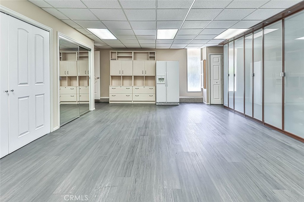 19051 Los Alimos Street Porter Ranch, CA 91326 - Photo 36 of 59 an empty room with wooden floor and a window
