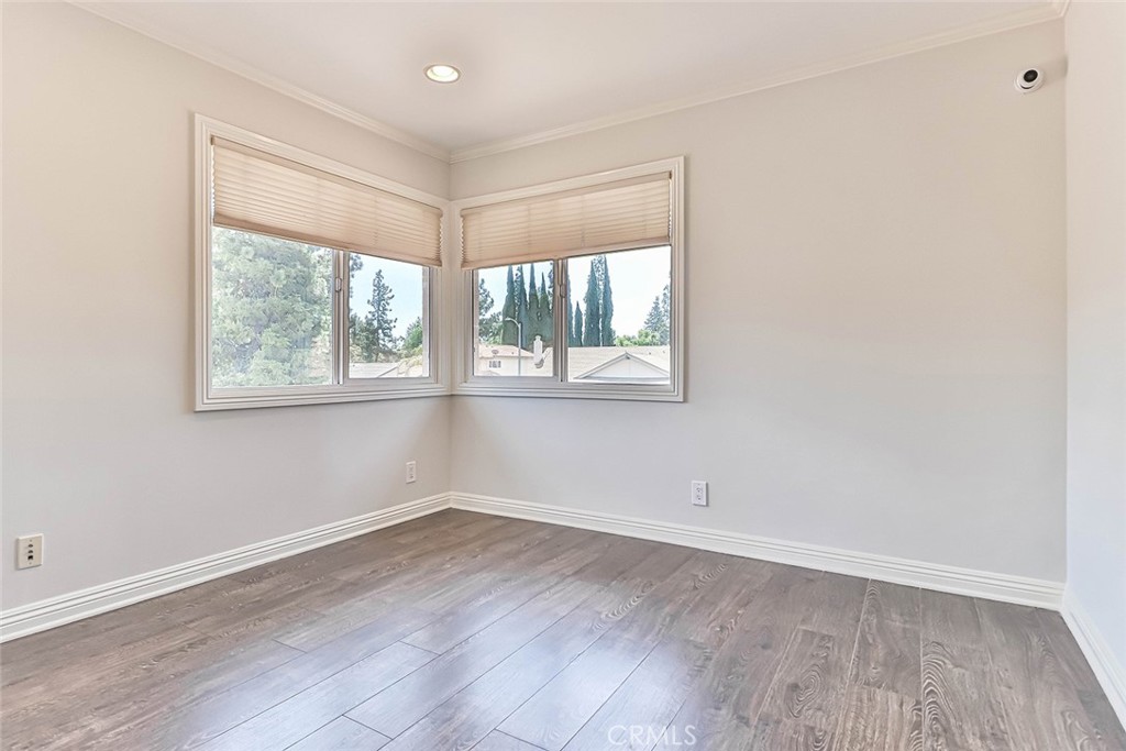 19051 Los Alimos Street Porter Ranch, CA 91326 - Photo 40 of 59 an empty room with wooden floor and windows