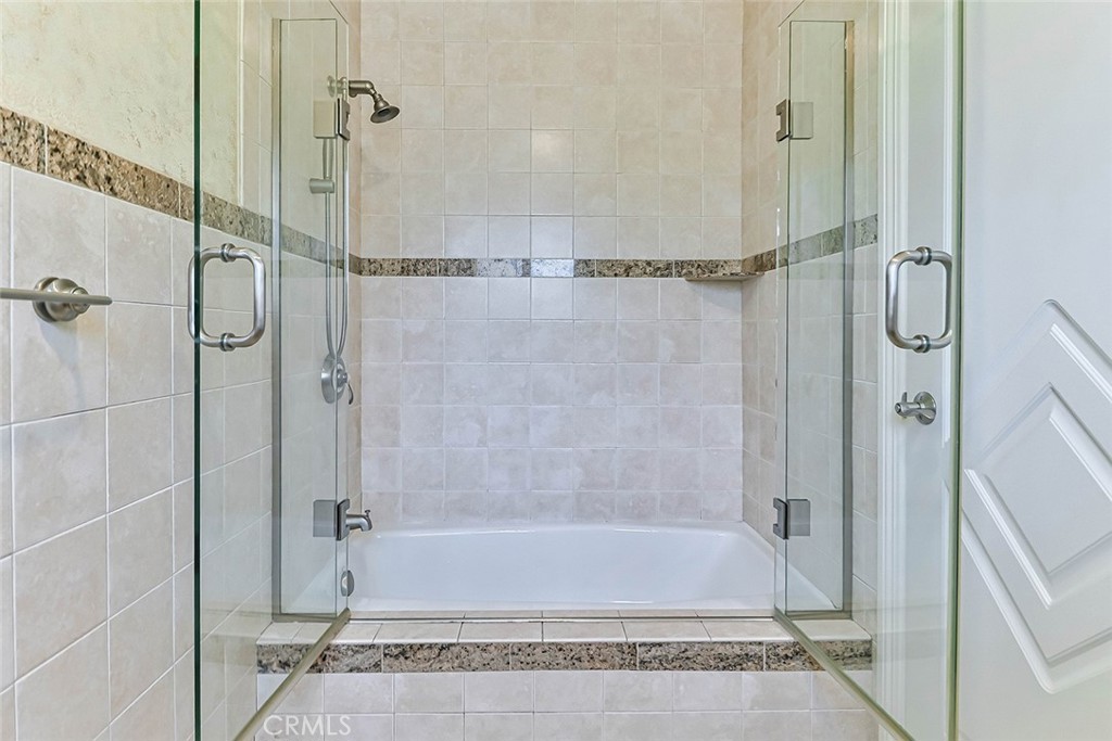 19051 Los Alimos Street Porter Ranch, CA 91326 - Photo 48 of 59 a bathroom with a shower and a bath tub