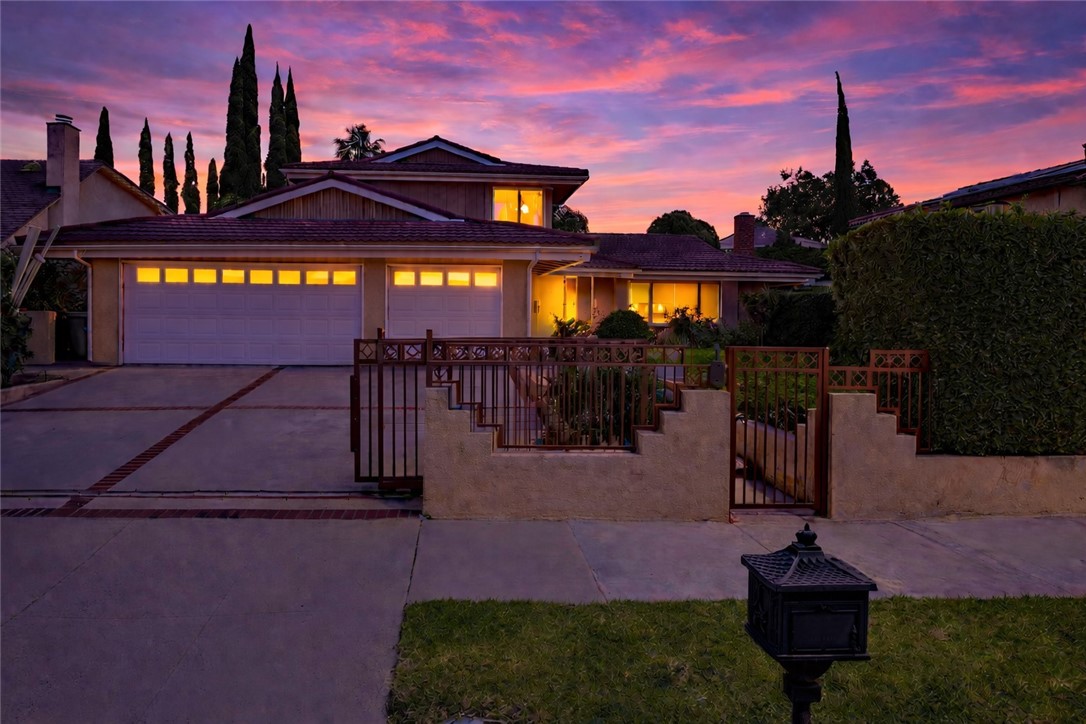 19051 Los Alimos Street Porter Ranch, CA 91326 - Photo 5 of 59 a front view of a house with a yard