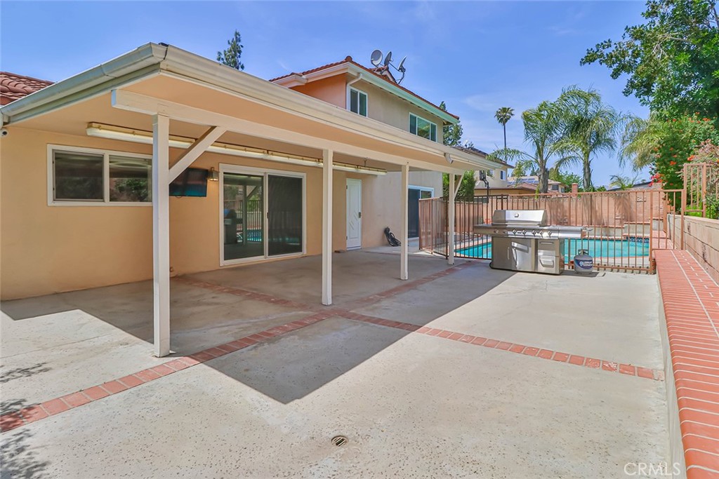 19051 Los Alimos Street Porter Ranch, CA 91326 - Photo 52 of 59 a front view of a house with a yard and potted plants