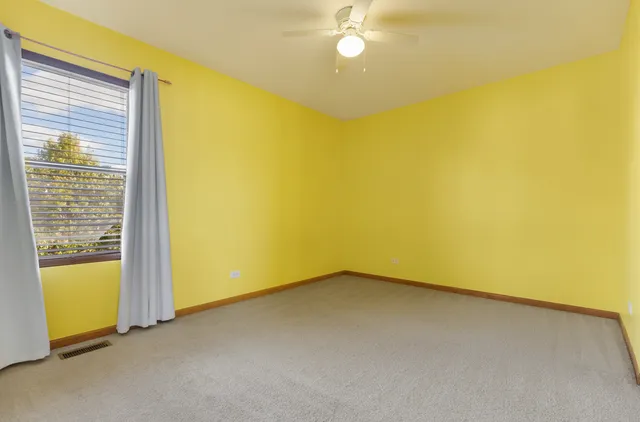 a view of a big room with wooden floor and windows