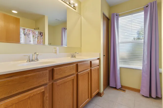 a bathroom with a double vanity sink and a mirror