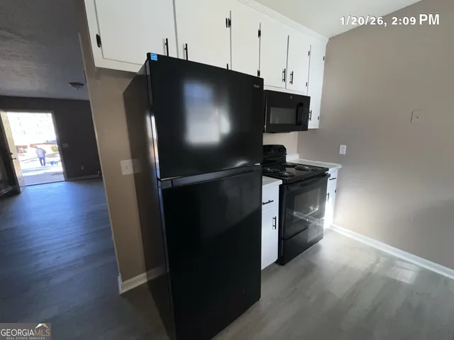 a kitchen with stainless steel appliances a refrigerator microwave and sink