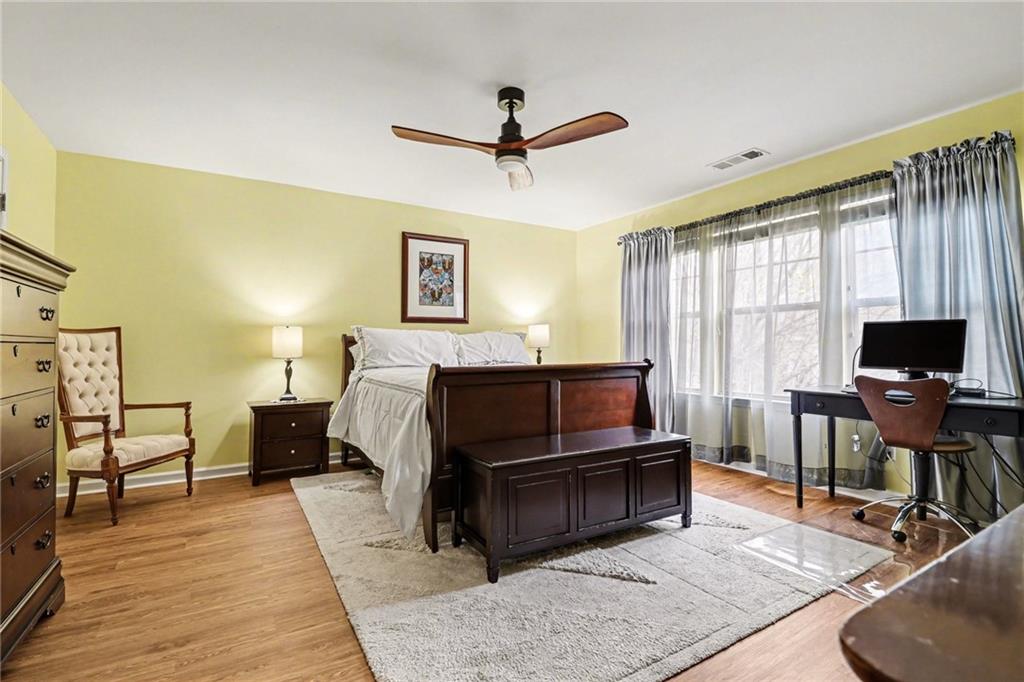 1180 Ridenour Boulevard, Unit 5 Kennesaw, GA 30152 - Photo 11 of 22 a bedroom with a bed and wooden floor