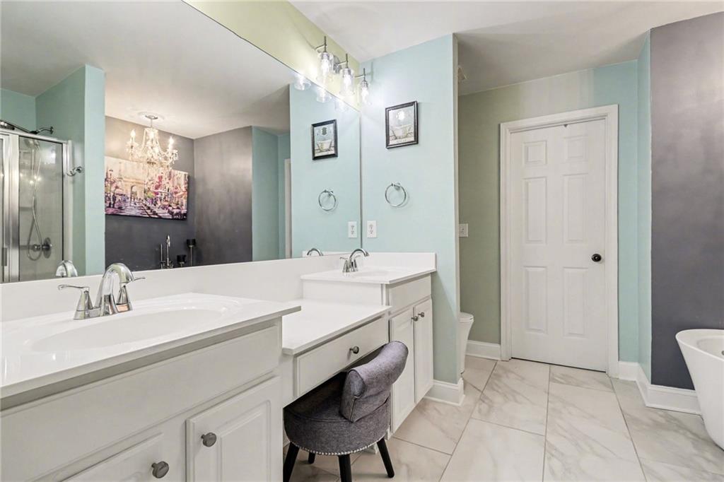 1180 Ridenour Boulevard, Unit 5 Kennesaw, GA 30152 - Photo 12 of 22 a bathroom with a sink and a mirror