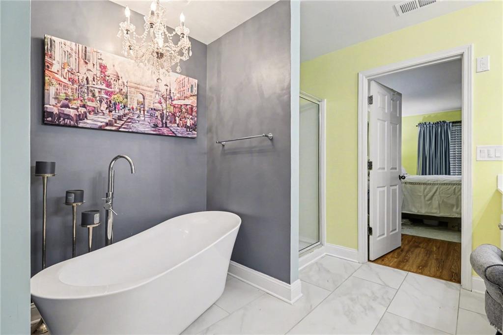 1180 Ridenour Boulevard, Unit 5 Kennesaw, GA 30152 - Photo 13 of 22 a bathroom with a sink a toilet and shower