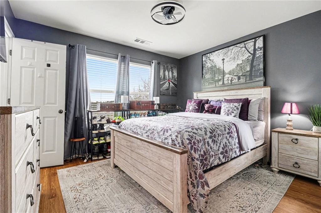 1180 Ridenour Boulevard, Unit 5 Kennesaw, GA 30152 - Photo 14 of 22 a bedroom with a bed and a dresser next to a window
