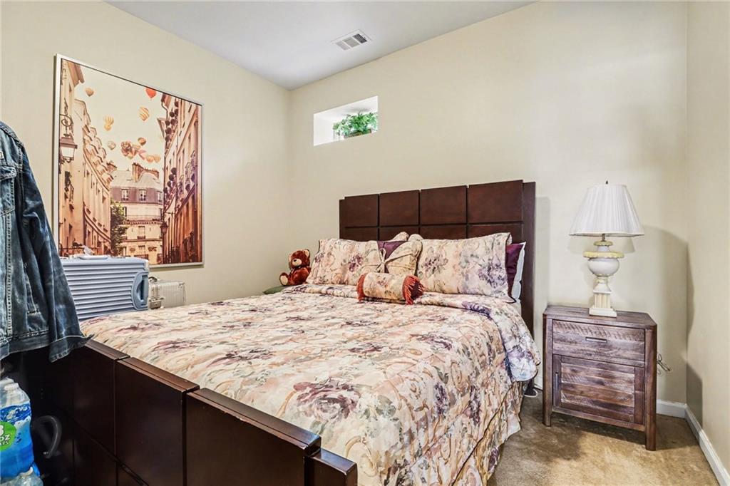 1180 Ridenour Boulevard, Unit 5 Kennesaw, GA 30152 - Photo 17 of 22 a bedroom with a bed and a window