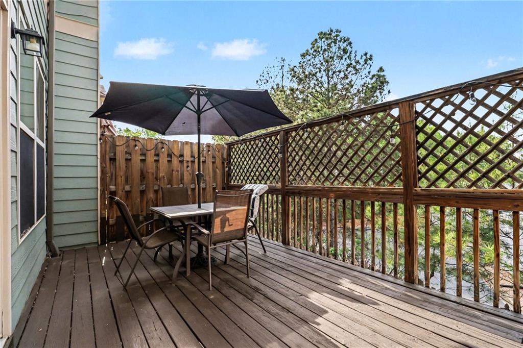 1180 Ridenour Boulevard, Unit 5 Kennesaw, GA 30152 - Photo 19 of 22 a patio with wooden floor and outdoor seating