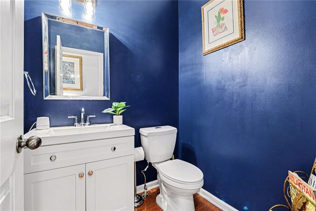1180 Ridenour Boulevard, Unit 5 Kennesaw, GA 30152 - Photo 9 of 22 a bathroom with a toilet sink and mirror
