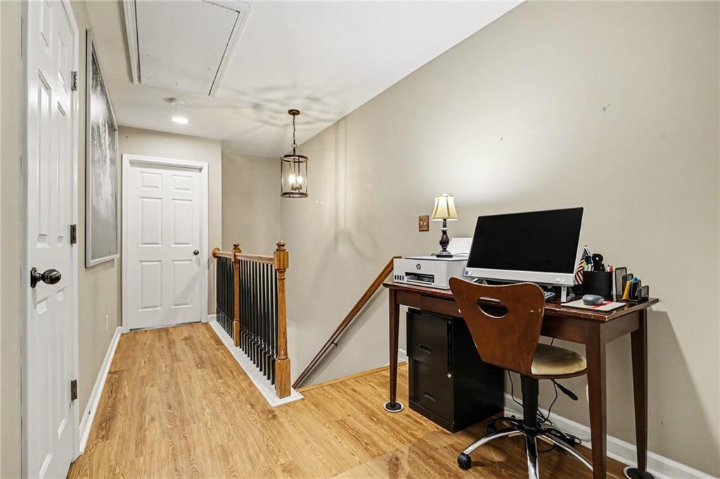 1180 Ridenour Boulevard, Unit 5 Kennesaw, GA 30152 - Photo 10 of 22 a view of a workspace with furniture and a flat screen tv